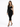 A model poses in a fitted black dress with a unique cutout design and one long sleeve, paired with strappy heels.