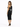 A woman poses in a fitted black dress with a one-shoulder design and cut-out details, paired with black heels.