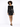 A model poses in a fitted, long-sleeve black dress adorned with shimmering sequins, paired with black heels.