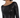 A close-up of a woman wearing a fitted black sequin dress with long sleeves and a boat neckline.