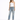 A woman poses in distressed light blue jeans with a white one-shoulder top and black high-heeled sandals.