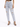 Light blue distressed jeans with a high waist and ripped details, paired with black strappy heels.
