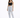 A model poses in light-wash ripped jeans paired with a black crop top and strappy heels against a white background.