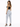 A woman stands with her back to the camera, wearing light blue jeans and a black crop top, paired with black heels.