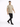 A man walks confidently in a light brown t-shirt paired with black jeans and sneakers.