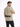 A man wearing a beige t-shirt with a large black "SIMPLIFY" graphic on the back, paired with dark jeans.