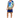 A man stands wearing a colorful short-sleeve shirt with tropical designs and matching shorts, paired with white sneak...