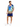 A man stands wearing a colorful short-sleeve shirt with tropical designs and matching shorts, paired with white sneak...