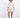 A model poses in a light beige button-up top and matching shorts, complemented by black open-toe heels.