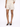 Light beige shorts paired with a matching top, complemented by black open-toe heels.