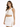 A model poses in a white cropped tank top with lace-up detailing and a matching skirt featuring side ties.