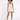A model poses in a light beige romper with a fitted bodice and flared shorts, paired with black heels.