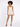 A model poses in a light beige romper with a fitted bodice and flared shorts, paired with black heels.