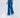 Blue wide-leg pants with an elastic waistband and side pockets, paired with white sneakers.
