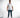 A man stands confidently wearing a white short-sleeve shirt with textured lettering, paired with blue jeans and styli...