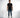 A man stands confidently in a black short-sleeve shirt with a bold graphic design, paired with blue jeans and stylish...
