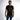 A man wearing a black t-shirt with a bold graphic text design stands confidently against a light background.