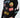 A man is wearing a black long-sleeve shirt adorned with colorful graphic designs and playful text.
