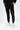 Black jogger pants with graphic text design, styled with white sneakers and a relaxed fit.