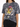 A model wearing a gray tie-dye t-shirt featuring a colorful tiger graphic and lightning bolt design.