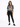 A woman stands wearing a gray tie-dye tee featuring a tiger graphic, paired with black skinny jeans and sneakers.