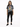 A woman stands wearing a gray tie-dye tee featuring a colorful tiger graphic, paired with black jeans and sneakers.