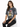 A woman sits wearing a gray tie-dye t-shirt featuring a colorful tiger graphic, paired with black jeans.