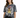 A woman wearing a tie-dye t-shirt featuring a bold tiger graphic, paired with black jeans.