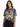 A woman wearing a tie-dye t-shirt featuring a bold tiger graphic, paired with black jeans.