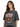 A woman with wavy hair wears a faded black t-shirt featuring an eagle graphic and bold text design.