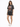 A model wearing a loose-fitting, dark graphic t-shirt paired with distressed black shorts and white sneakers.