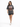 A woman walks confidently in a loose-fitting gray t-shirt featuring an eagle graphic and casual shorts.