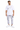 A man stands wearing a white graphic t-shirt and light gray cargo pants, paired with white sneakers.