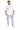 A man stands wearing a white oversized t-shirt with graphic text and light gray cargo pants, paired with white sneakers.