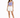 A woman stands confidently in a light purple cropped top paired with white shorts and sneakers.