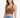 A woman with long hair wears a fitted brown ribbed crop top paired with high-waisted distressed denim shorts.