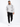 A man walks confidently in a light gray hoodie and black cargo pants, paired with white sneakers.