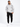 A man stands confidently in a light gray hoodie with a graphic design, paired with black cargo pants and white sneakers.