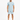 A man stands wearing a light blue ribbed t-shirt and matching shorts, paired with black and white sneakers.