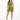 A model poses in olive green fitted shorts and a matching one-shoulder crop top, paired with white sneakers.