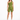 A model poses in a one-shoulder olive green top paired with matching bike shorts and white sneakers.