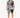 A man stands wearing a short-sleeve shirt and matching shorts with a black and white palm leaf pattern.