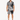A man stands wearing a short-sleeve shirt and matching shorts with a black and white palm leaf pattern.