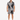 A man stands wearing a short-sleeve shirt and matching shorts with a black and white palm leaf pattern.