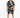A man stands wearing a short-sleeve, patterned button shirt and matching shorts, paired with white sneakers.
