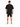 A person stands with their back to the camera, wearing a loose black t-shirt and black shorts with white numbers.