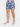 Men's swim shorts with a tropical leaf pattern, paired with white slide sandals featuring bold text.