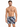 A man stands confidently in colorful swim trunks featuring a modern abstract pattern, showcasing a relaxed summer vibe.