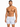 A man with a toned physique poses in swim trunks featuring a colorful sailboat pattern on a white background.