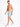 A shirtless man poses in colorful swim trunks featuring a tropical print, paired with white slide sandals.